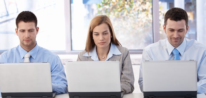 Decorative image: three business people working on laptops